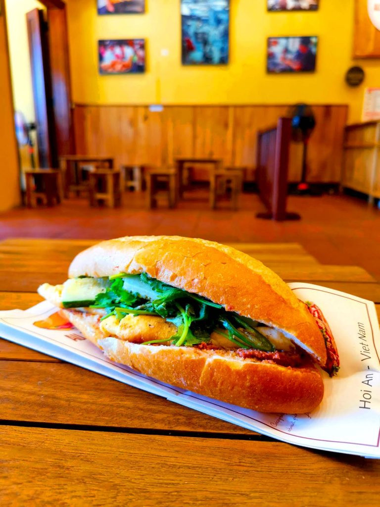 Bánh mì Hội An đậm đà hương vị truyền thống với pa tê, thịt và rau xà lách tươi ngon, được bày trí đẹp mắt tại All Day Bánh Mì.