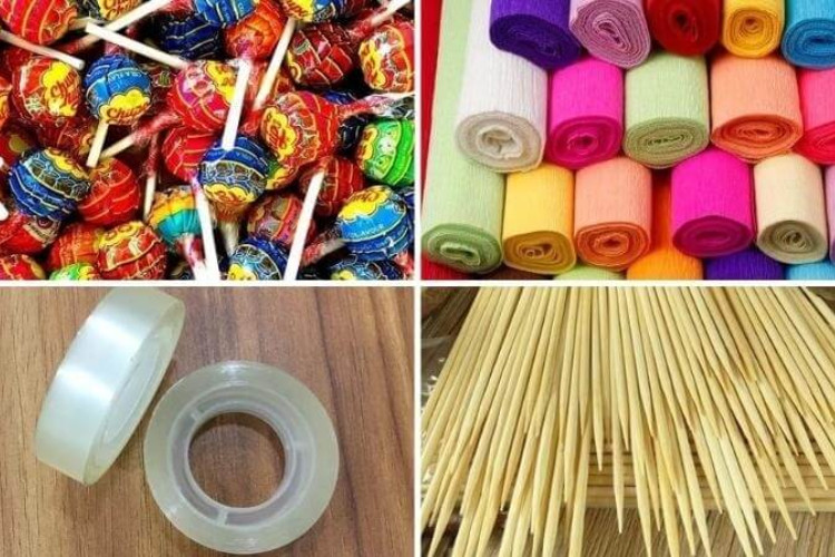 Bộ dụng cụ làm bó hoa bánh kẹo bao gồm kéo, băng dính, súng bắn keo và que gỗ.