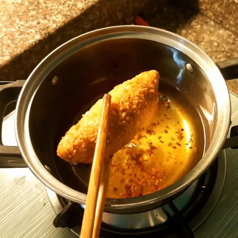 Chiên bánh su kem trong chảo dầu nóng, vỏ ngoài giòn rụm