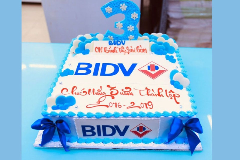 Bánh khai trương màu xanh dương với logo doanh nghiệp