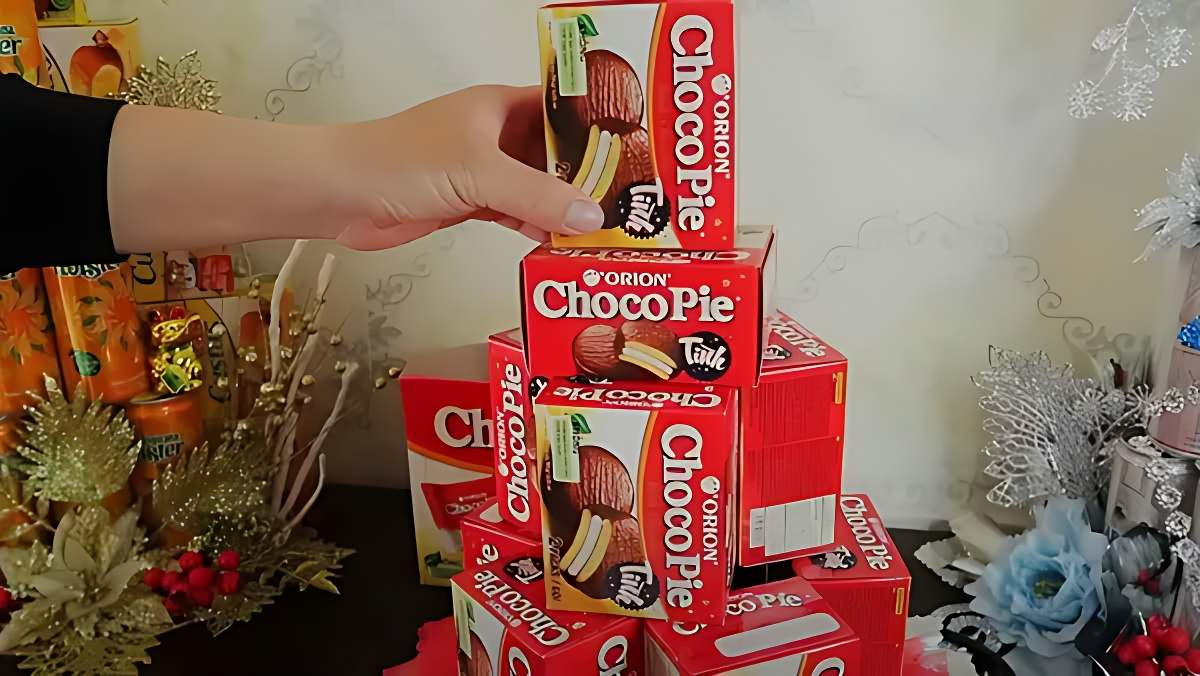 Hình ảnh bước đầu trong cách làm tháp bánh Choco-Pie, sắp xếp các hộp bánh trên đế vững chắc.